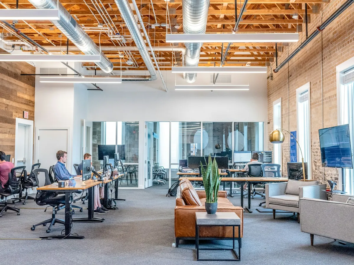 Financial analysts working at workstations in an enterprise office