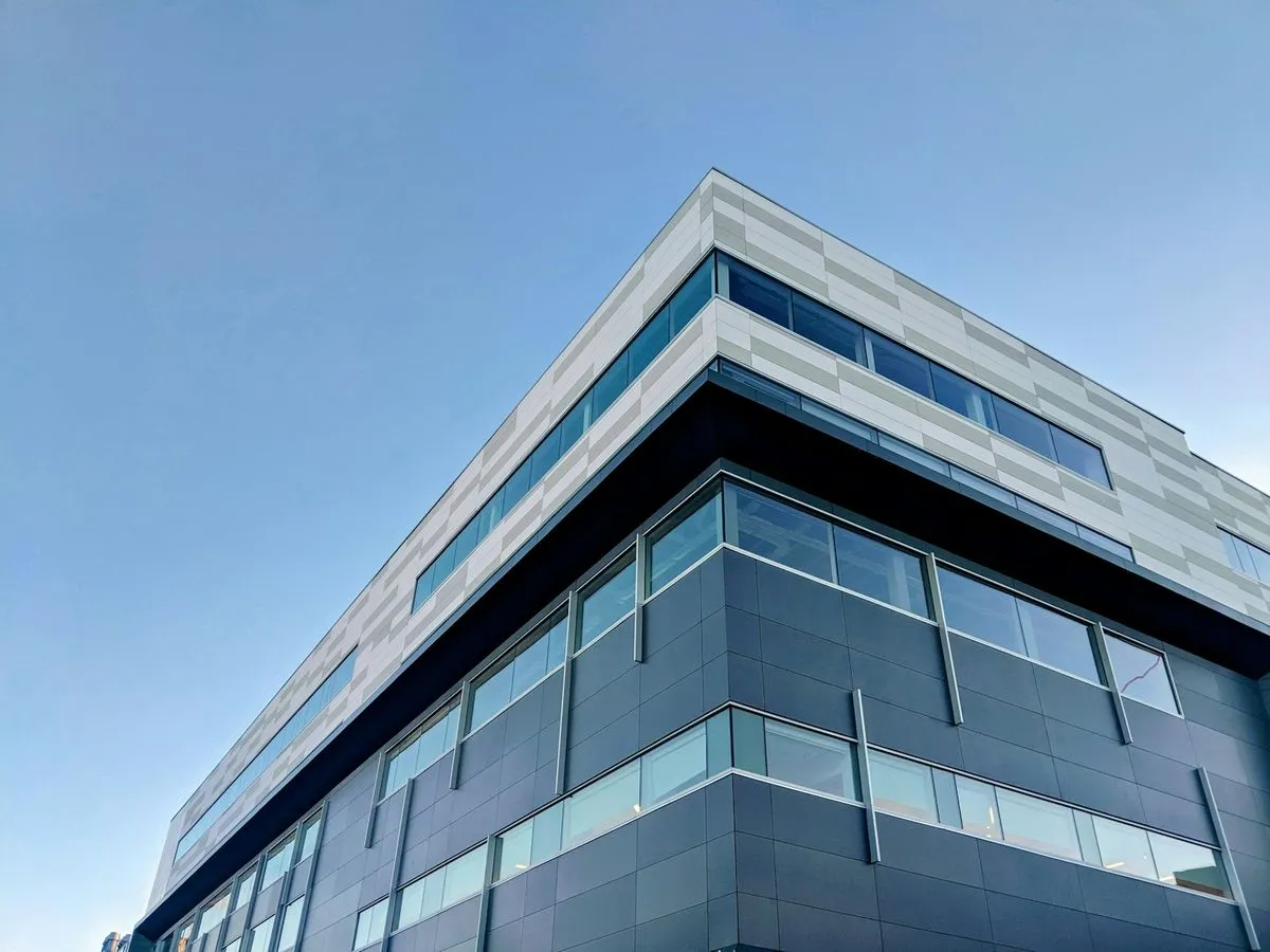 Modern commercial office building against a blue sky
