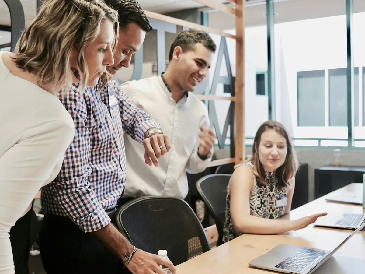 Colleagues reviewing client documentation in an airy corporate workspace